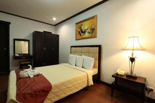 Postel nebo postele na pokoji v ubytování D' Leonor Hotel