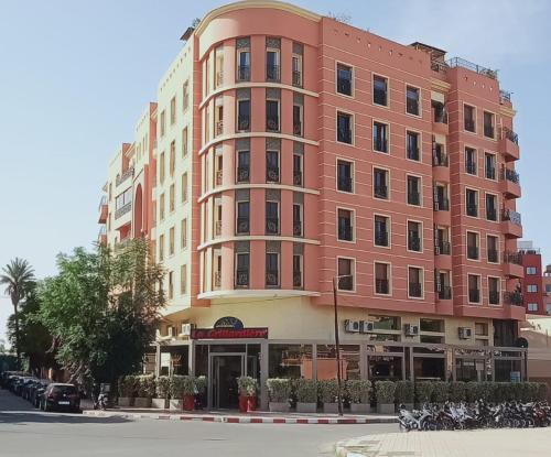 a large pink building on the side of a street at Charming Oasis in Marrakesh in Marrakech