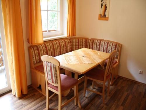 a dining room with a wooden table and chairs at Apartment in Grossarl near Ski Slopes in Grossarl