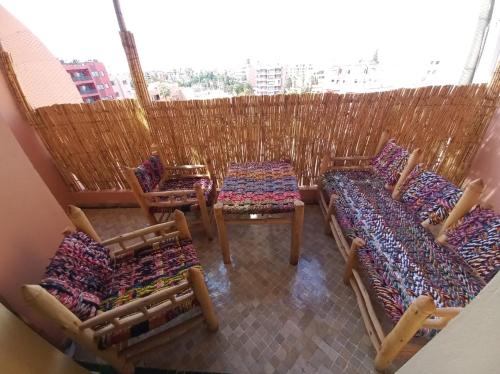 a group of chairs and tables in a room at Charming Oasis in Marrakesh in Marrakech