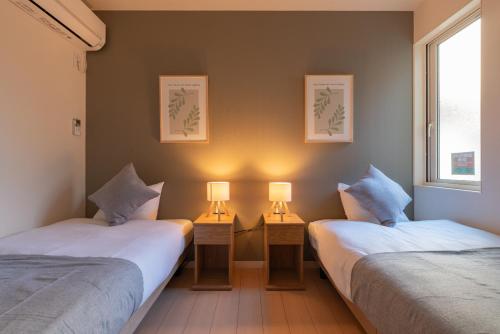 Ένα ή περισσότερα κρεβάτια σε δωμάτιο στο 10 min walk Nagoya Sta 6 BR 18 ppl 2 free PK