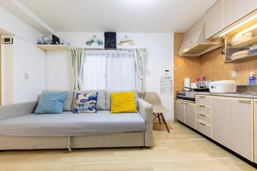 a living room with a couch in a kitchen at Akazu-hostel new-ST0112 in Naka-tomi