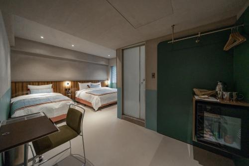 En eller flere senge i et værelse på PAPO'A Labs