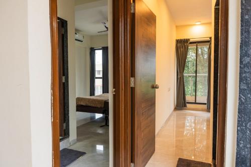a hallway with a door leading to a room at Villa 29 - 3BHK Villa with Private Pool in Khopoli in Pali