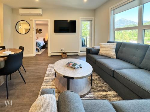 a living room with a couch and a table at Paradise Point - Hot Tub & Mountain Views in Golden