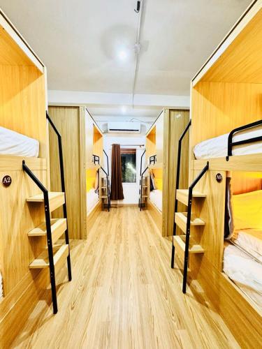 a room with four bunk beds and a hallway at Demi Cafe and Hostel in Vientiane