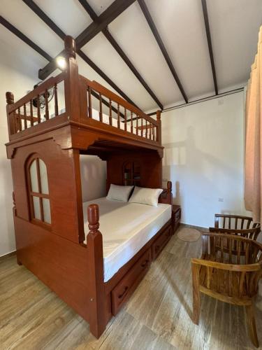 a large wooden bed in a room with at Euphoria Villa in Hikkaduwa
