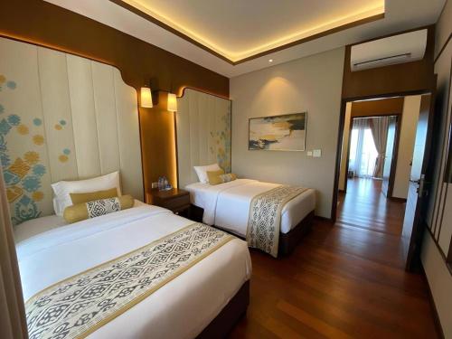 Postel nebo postele na pokoji v ubytování Putri Duyung Ancol
