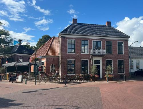 a brick building on a street in a city at Gastenverblijf Hunsingo in Winsum
