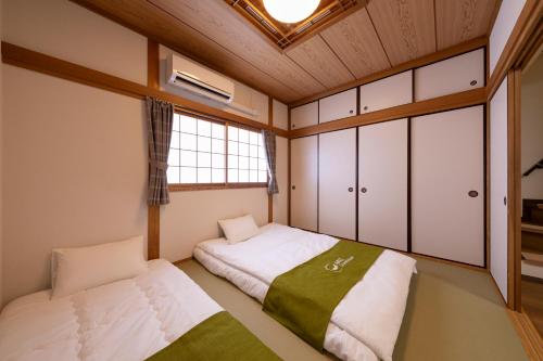 Postel nebo postele na pokoji v ubytování 青羽-橘山