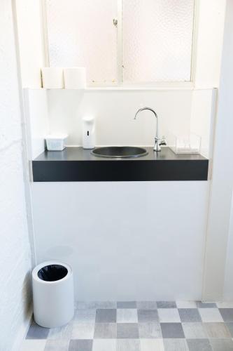 a kitchen with a sink and a window at rice house in Kumamoto