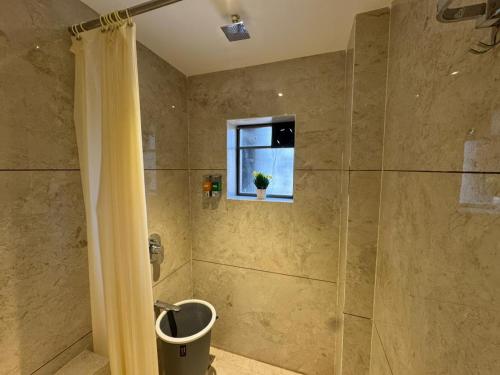a bathroom with a shower with a shower curtain at Hotel Sai Seeta Palace Newly Renovated in Shirdi