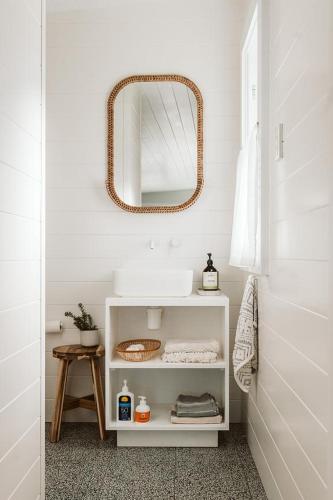 a bathroom with a sink and a mirror at George @ Ethel & Odes in Bundeena