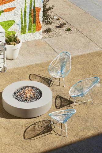 three chairs and a fire pit on the ground at Avatar Hotel Santa Clara, Tapestry Collection by Hilton in Santa Clara