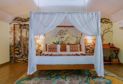 a bedroom with a bed with a canopy at ONENESS Rishikesh by Ganga Kinare - A Luxury Wilderness Resort in Rishīkesh