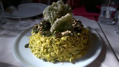 a plate of pasta with broccoli and nuts on a table at La Locanda Di Cadì in Petralia Soprana