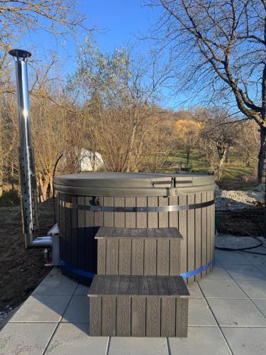 a hot tub sitting on a sidewalk in a park at Willow32 Chalet in Braşov