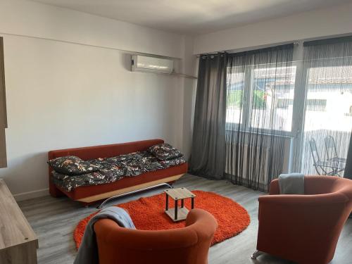a living room with a couch and two chairs at AN Studio in Craiova