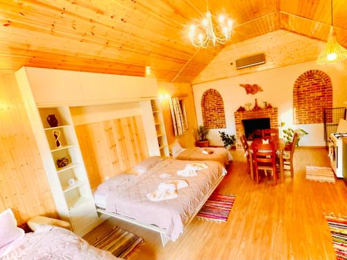 a bedroom with a bed and a living room at Chalet Harmony in Bagdatʼi