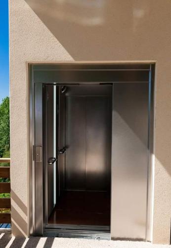 a metal door in the side of a building at Logis Hôtels Troglododo in Azay-le-Rideau