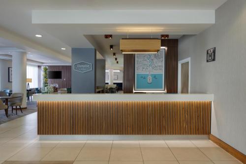 a lobby with a reception desk in a building at Hampton by Hilton Bournemouth in Bournemouth