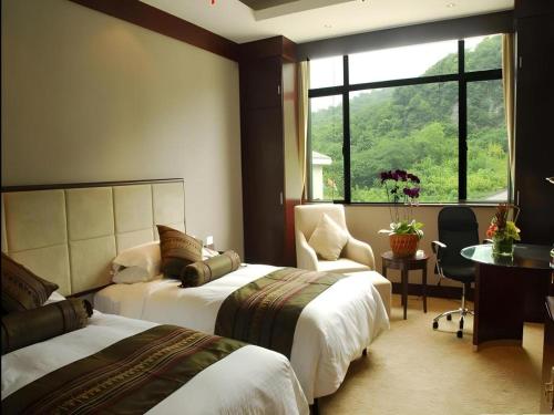 Ένα ή περισσότερα κρεβάτια σε δωμάτιο στο West Lake Hillview Int'L Hotel