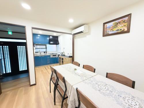 a kitchen and dining room with a table and chairs at Osaka Large House 13Guests 5BR 3Bath 3Shower in Osaka