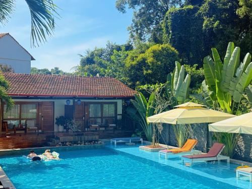 a group of people in a swimming pool at Bauhinia Resort & Spa Phu Quoc in Phú Quốc