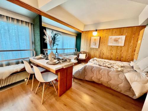 a bedroom with a bed and a table and chairs at Suite Albare, Marilleva 1400, Val di Sole in Marilleva