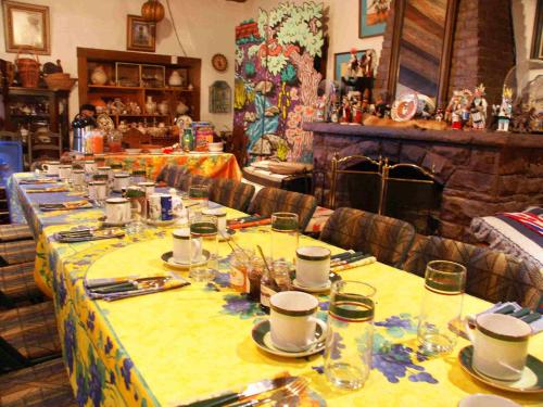 a long table with plates and cups on it at Inn at Halona in Zuni