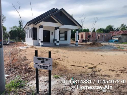 a house under construction with a sign in front of it at Homestay Ain in Kuala Terengganu