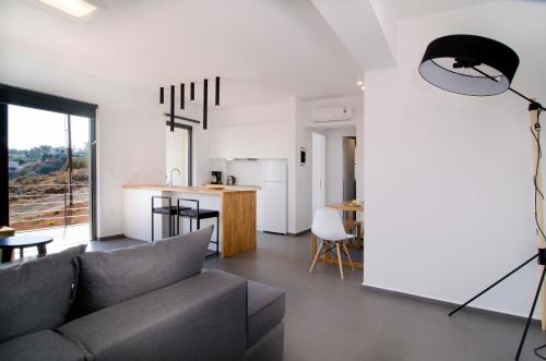 a living room with a couch and a kitchen at Seametry Apartments in Souda