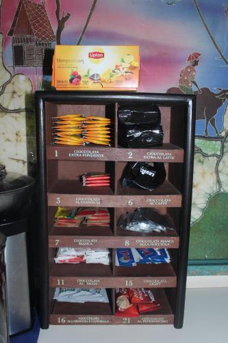 a book shelf filled with lots of clothes at Los Flamingos in La Maddalena