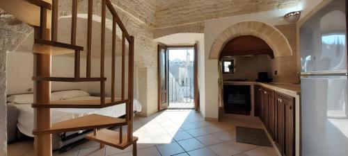a kitchen with a spiral staircase in a house at Dimora Conte, Alberobello in Alberobello