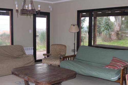 a living room with a couch and a coffee table at Quinta El Monte in Tandil