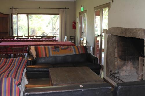 a living room with a couch and a fireplace at Quinta El Monte in Tandil