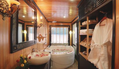 a bathroom with a sink and a toilet and a sink at Starlight Cruise Ha Long in Ha Long