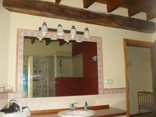 Casa del Tesoro في Triongo: مرآة فوق حوض في الحمام