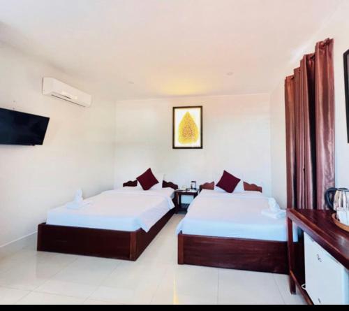 Postel nebo postele na pokoji v ubytování Elmas Hotel Siem Reap