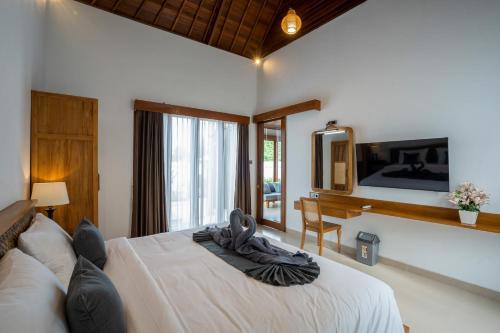 Ένα ή περισσότερα κρεβάτια σε δωμάτιο στο Ulu dawa Pandawa Cottage