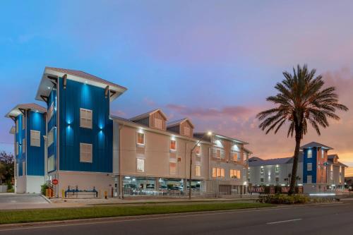 a building with a palm tree next to a street at The J Hotel Dunedin Clearwater, an Ascend Collection Hotel in Dunedin