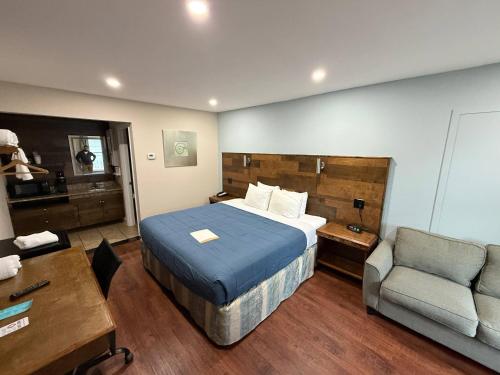 een slaapkamer met een bed, een bank en een stoel bij Southern Oaks Inn St Augustine Historic District in St. Augustine