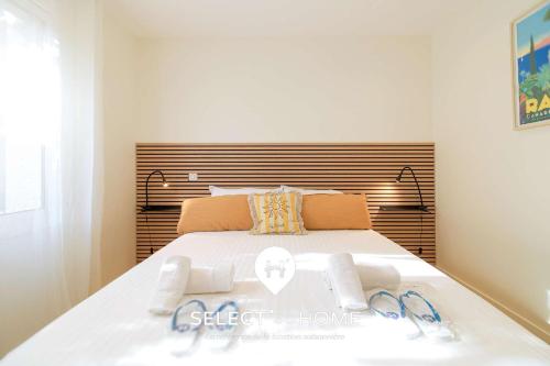 a bedroom with a large white bed with two towels on it at SELECT'soHOME - Jardin vue mer à Pramousquier - ASTRA in Rayol-Canadel-sur-Mer