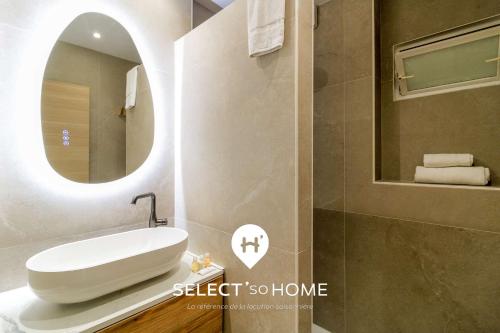 a bathroom with a white sink and a mirror at SELECT'soHOME - Jardin vue mer à Pramousquier - ASTRA in Rayol-Canadel-sur-Mer