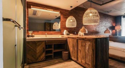 a bathroom with a sink and a mirror at Tropical Hideaway in Seogwipo