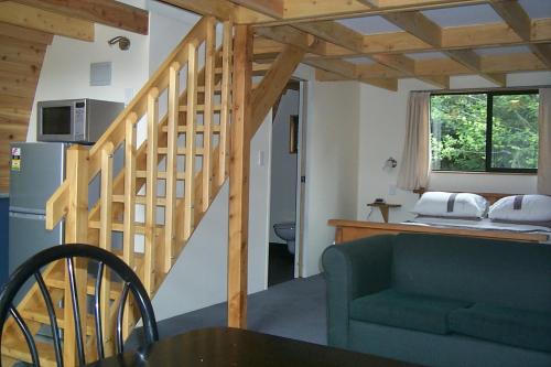 a living room with a staircase and a couch at Wetland View Park in Anatori