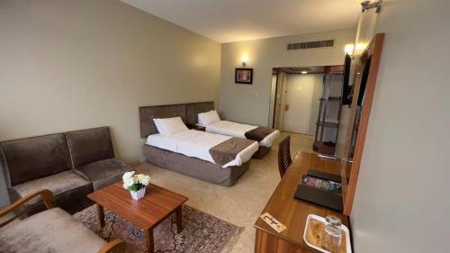 卡拉奇Faran Hotel的带床和沙发的客厅