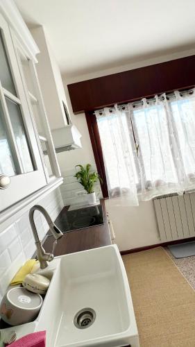a kitchen with a sink and some windows at Casa sul fiume in Gorgo
