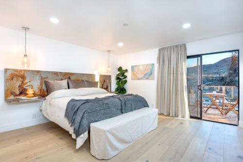 a bedroom with a bed and a large window at Mountain Views, Pool, Spa & Serenity Stargate in Yucca Valley