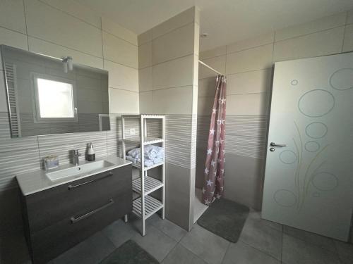 a bathroom with a sink and a shower at Maisonnette 2 à 4 personnes 